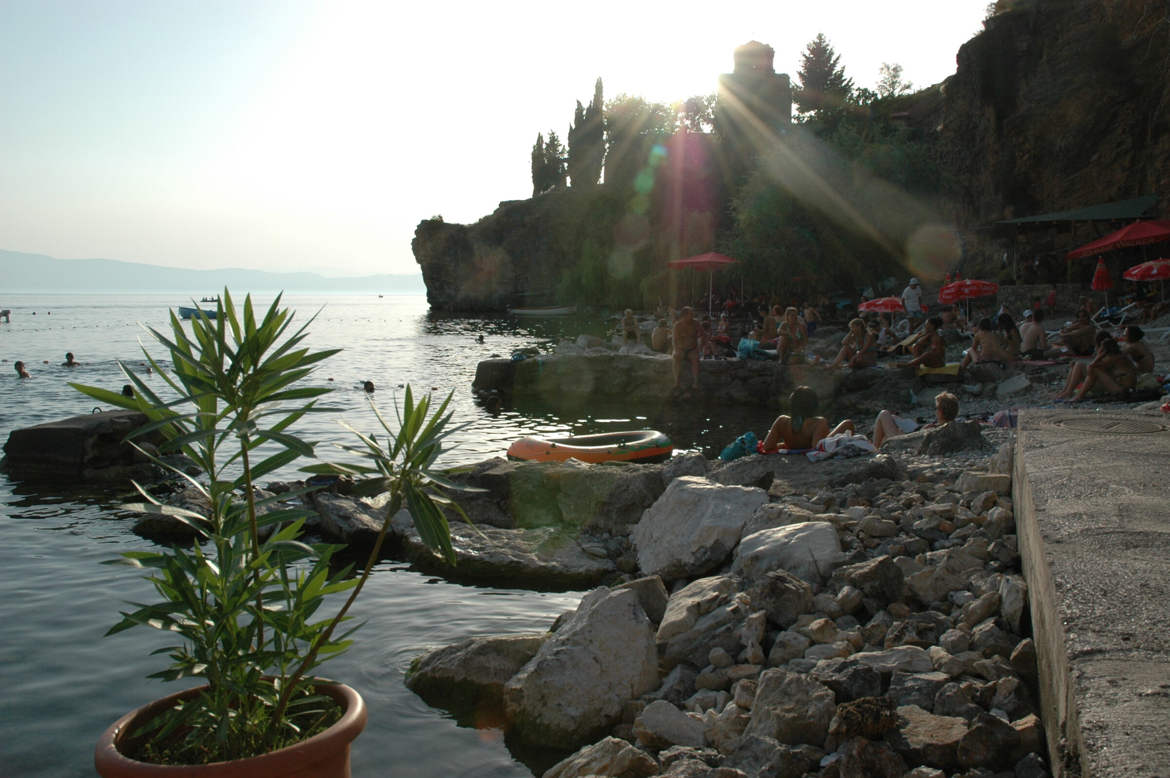 Bathers on the pebble shore of Kaneo Beach below the Church of St John at Kaneo, Lake Ohrid